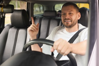 Photo of Man driving modern car, view through window