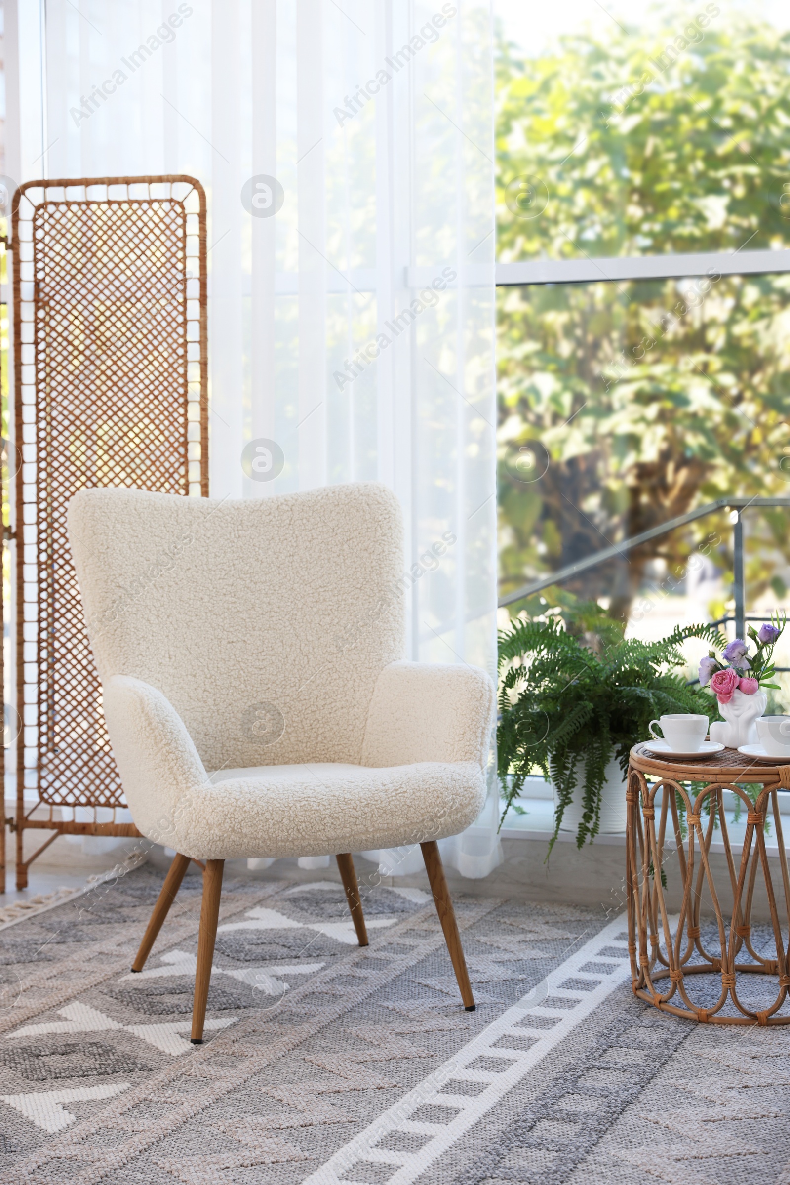 Photo of Stylish living room interior with soft white armchair