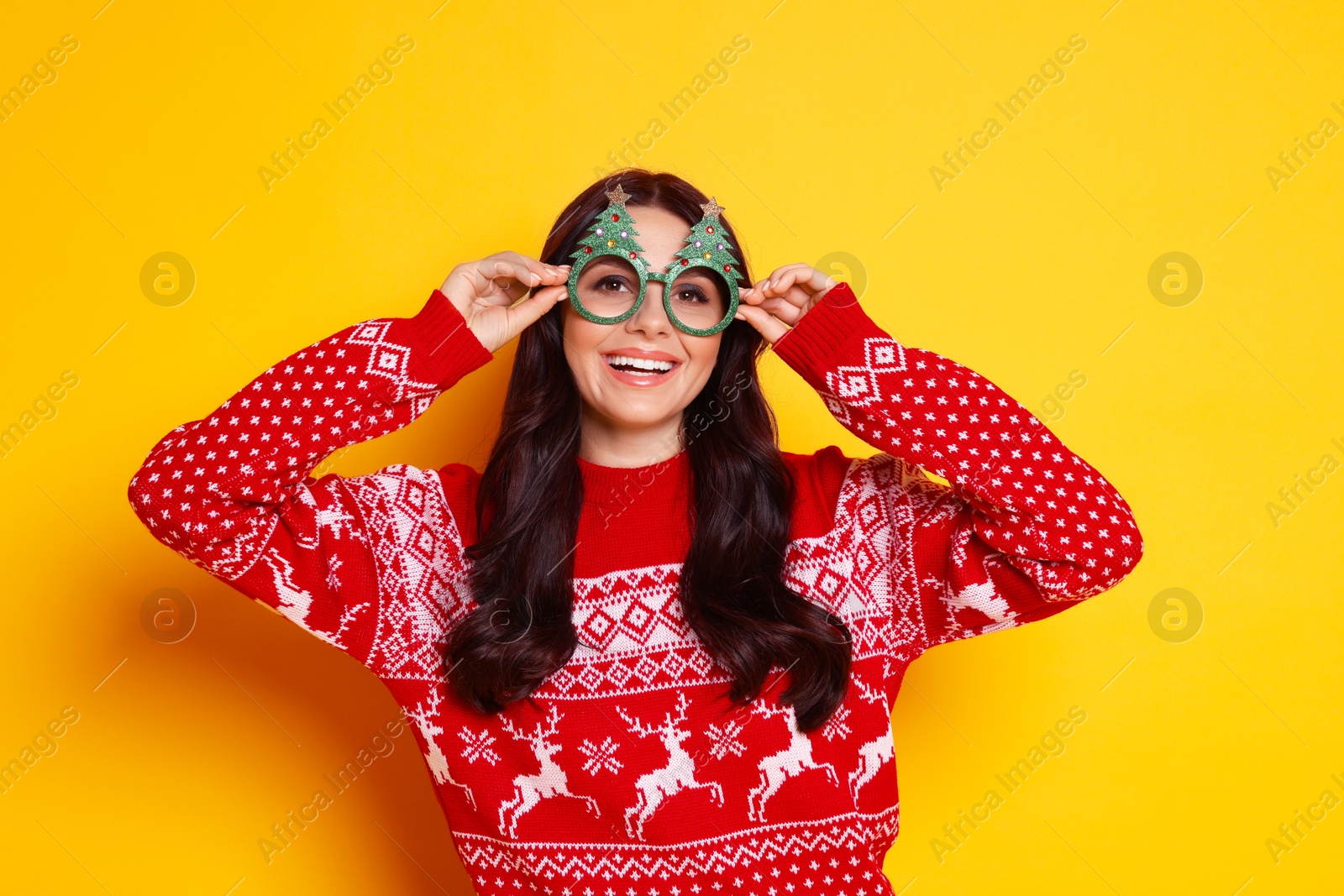 Photo of Happy woman with party glasses on yellow background. Christmas celebration