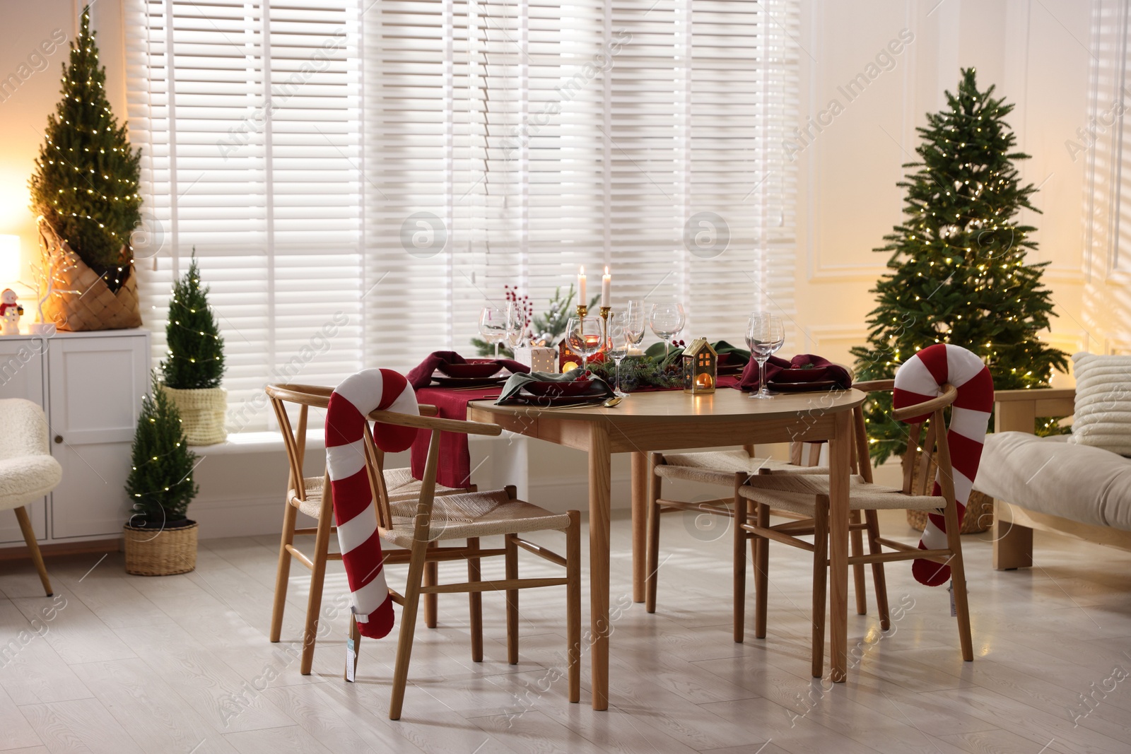 Photo of Christmas table setting with stylish dishware and festive decor indoors