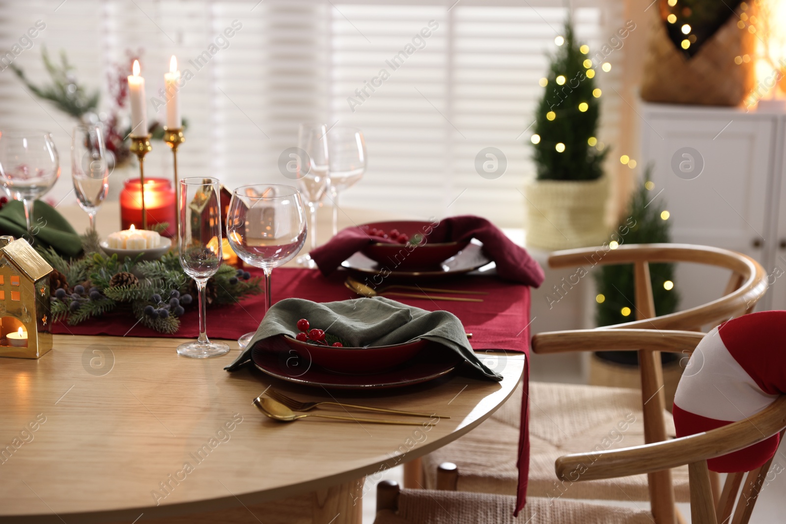 Photo of Christmas table setting with stylish dishware and festive decor indoors