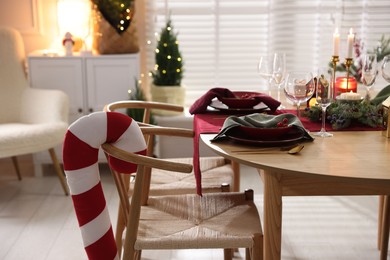 Photo of Christmas table setting with stylish dishware and festive decor indoors