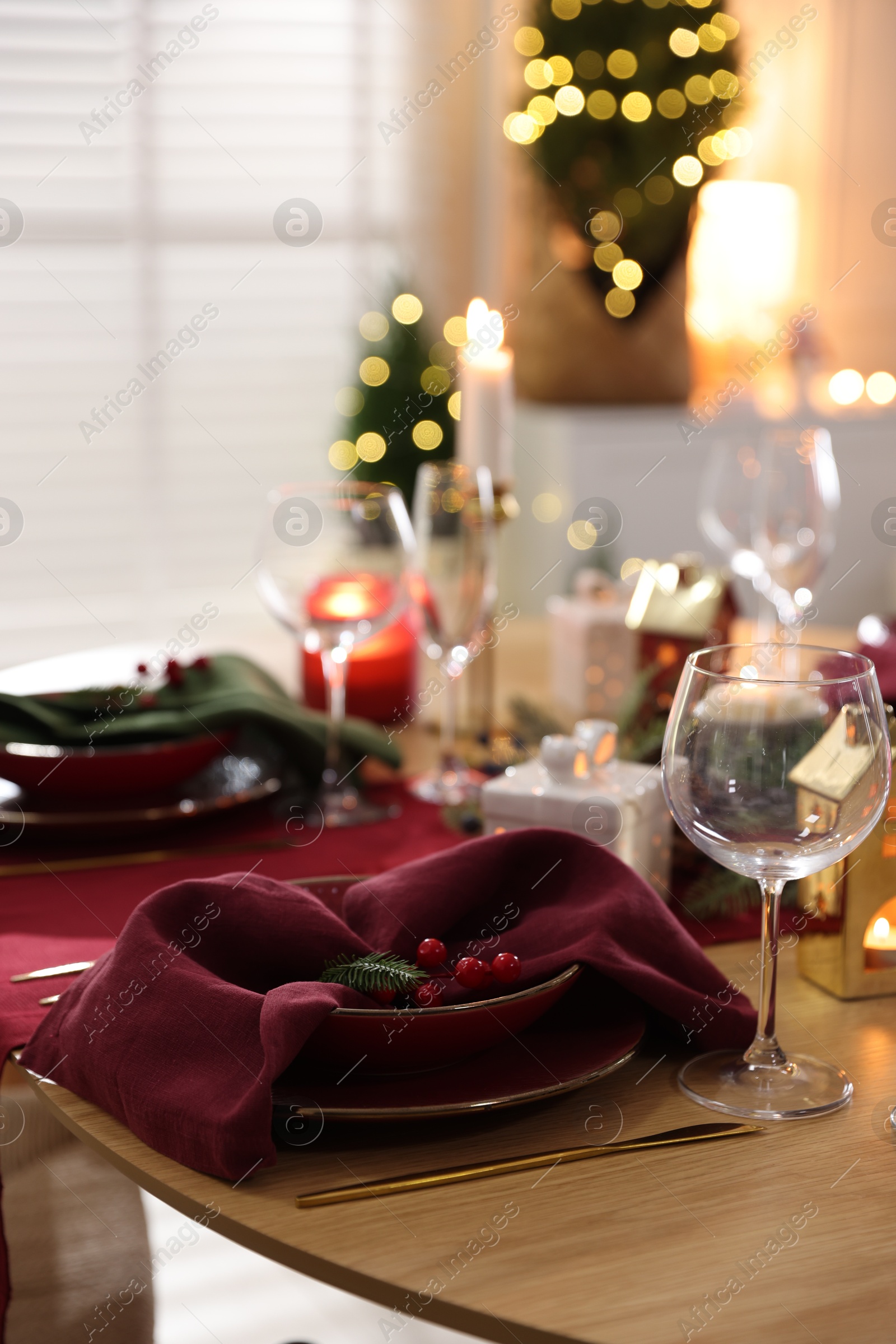 Photo of Christmas table setting with stylish dishware and festive decor indoors