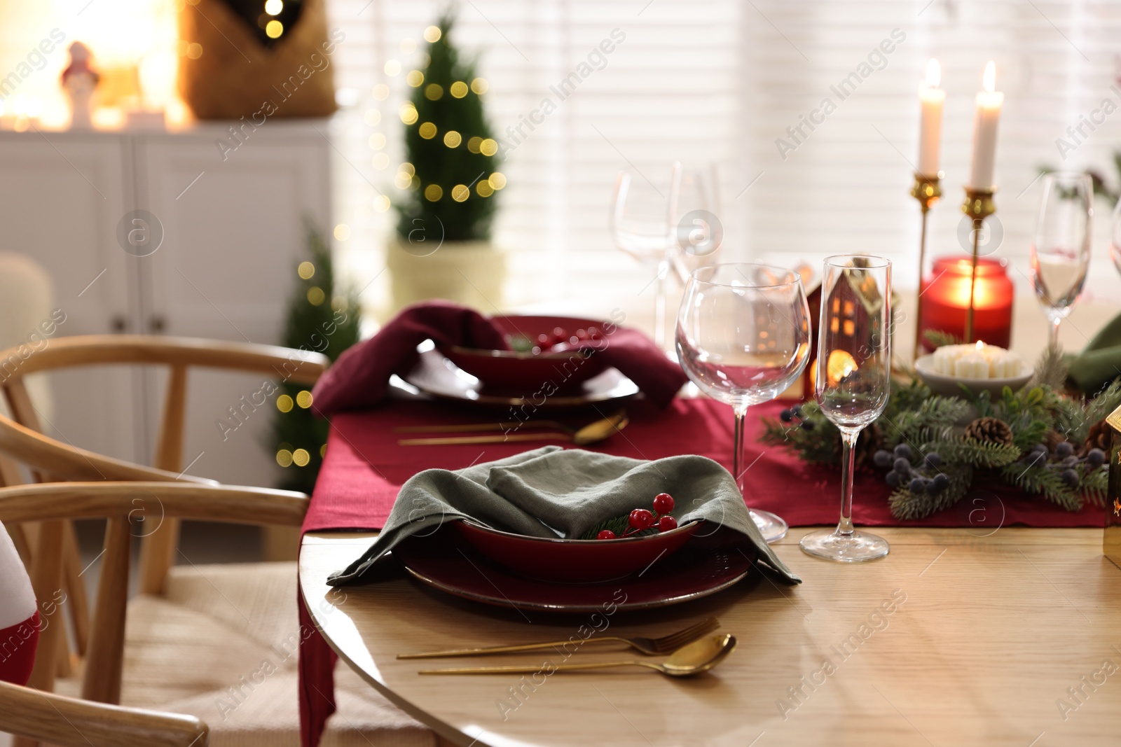 Photo of Christmas table setting with stylish dishware and festive decor indoors