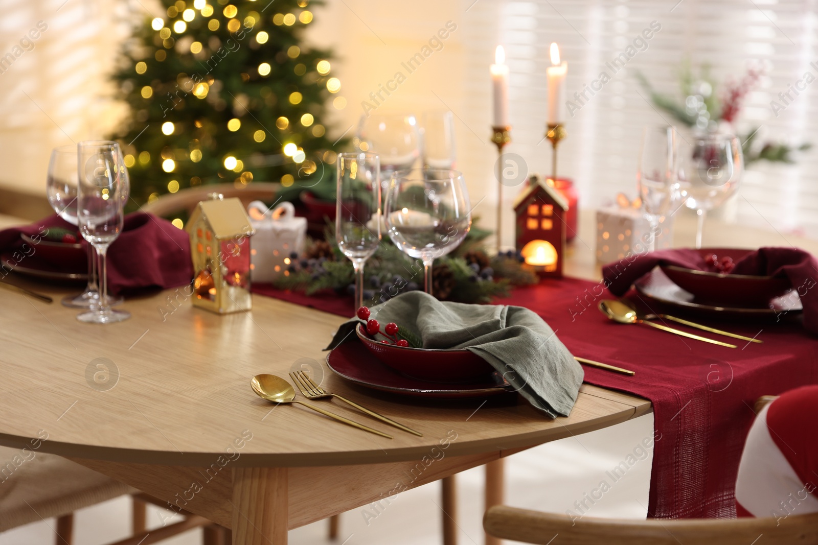 Photo of Christmas table setting with stylish dishware and festive decor indoors