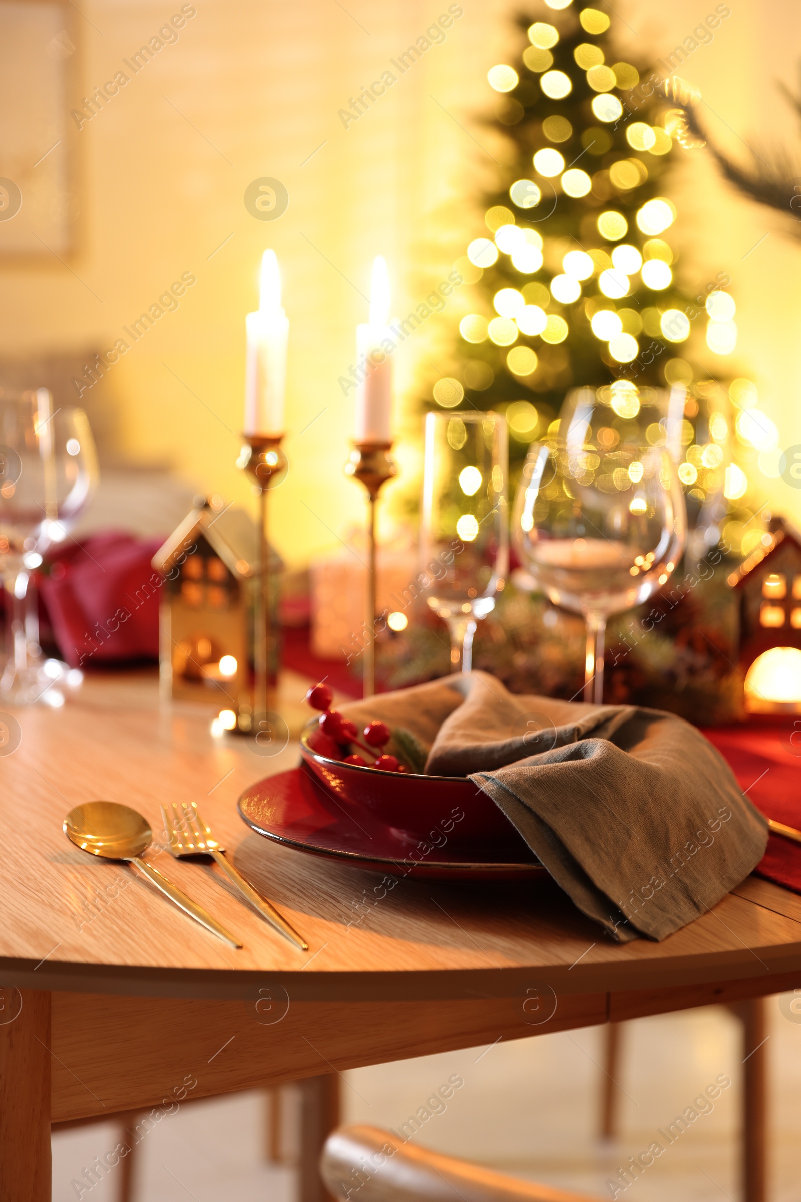 Photo of Christmas table setting with stylish dishware and festive decor indoors