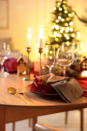 Photo of Christmas table setting with stylish dishware and festive decor indoors