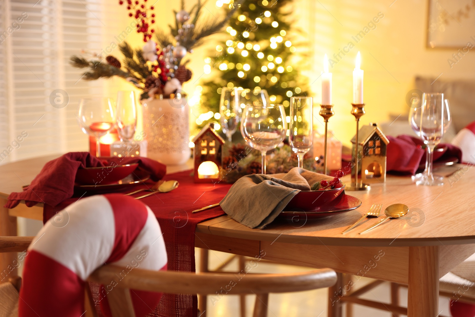 Photo of Christmas table setting with stylish dishware and festive decor indoors