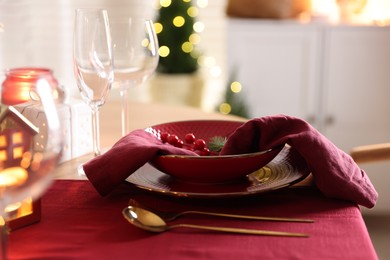 Photo of Christmas table setting with stylish dishware and festive decor indoors, closeup