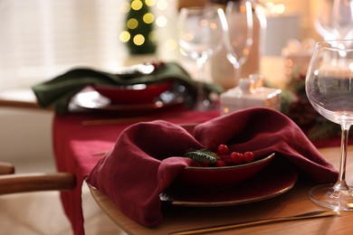 Photo of Christmas table setting with stylish dishware and festive decor indoors, closeup