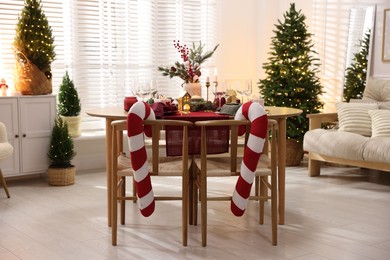 Photo of Christmas table setting with stylish dishware and festive decor indoors