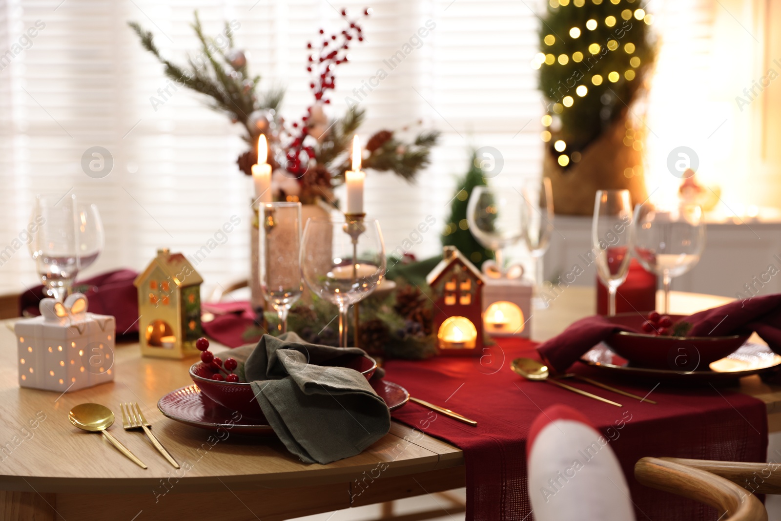 Photo of Christmas table setting with stylish dishware and festive decor indoors