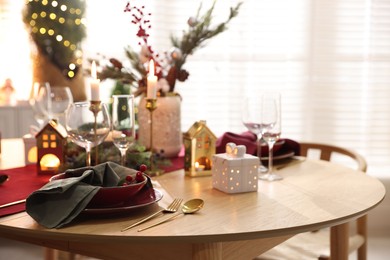 Photo of Christmas table setting with stylish dishware and festive decor indoors