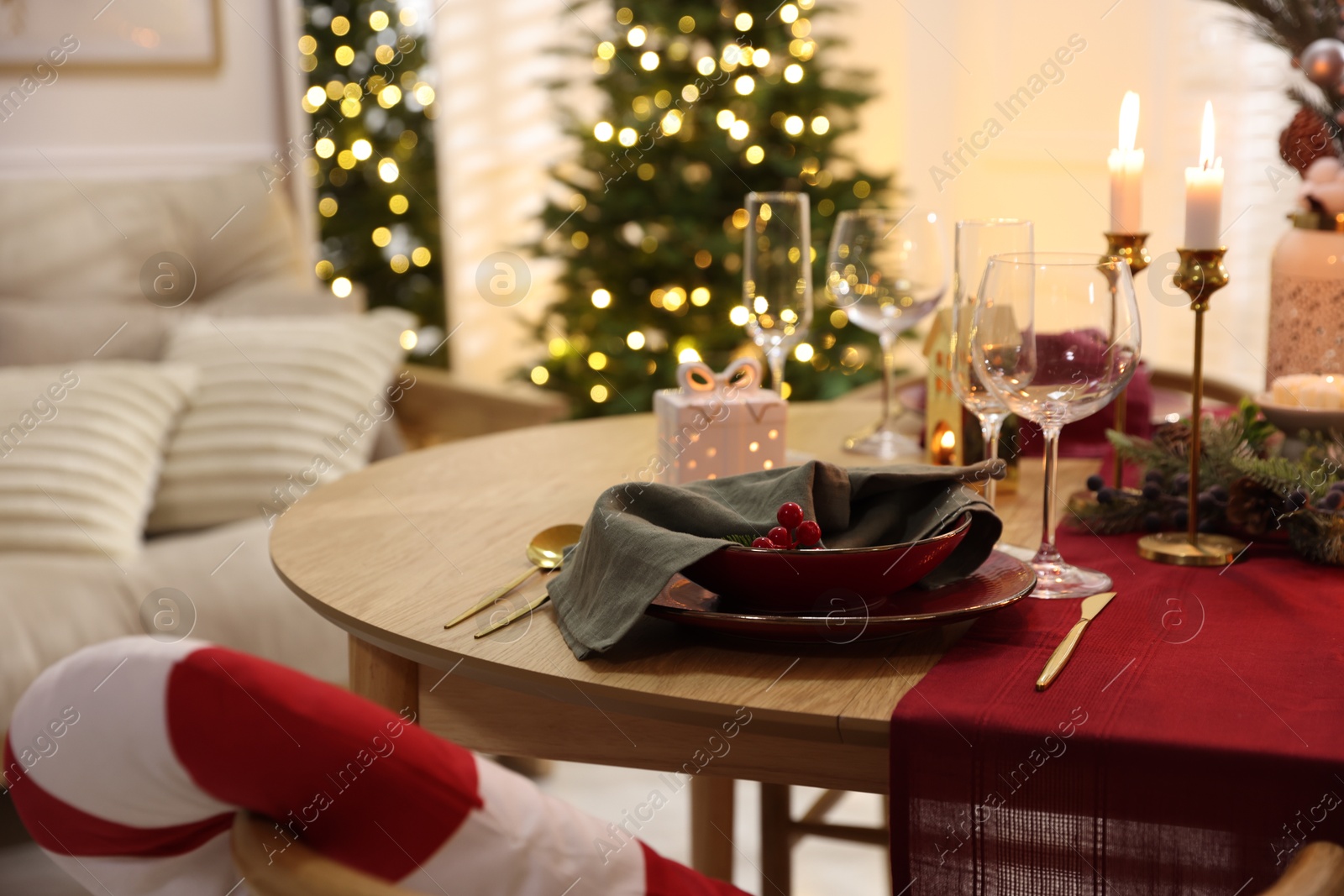 Photo of Christmas table setting with stylish dishware and festive decor indoors