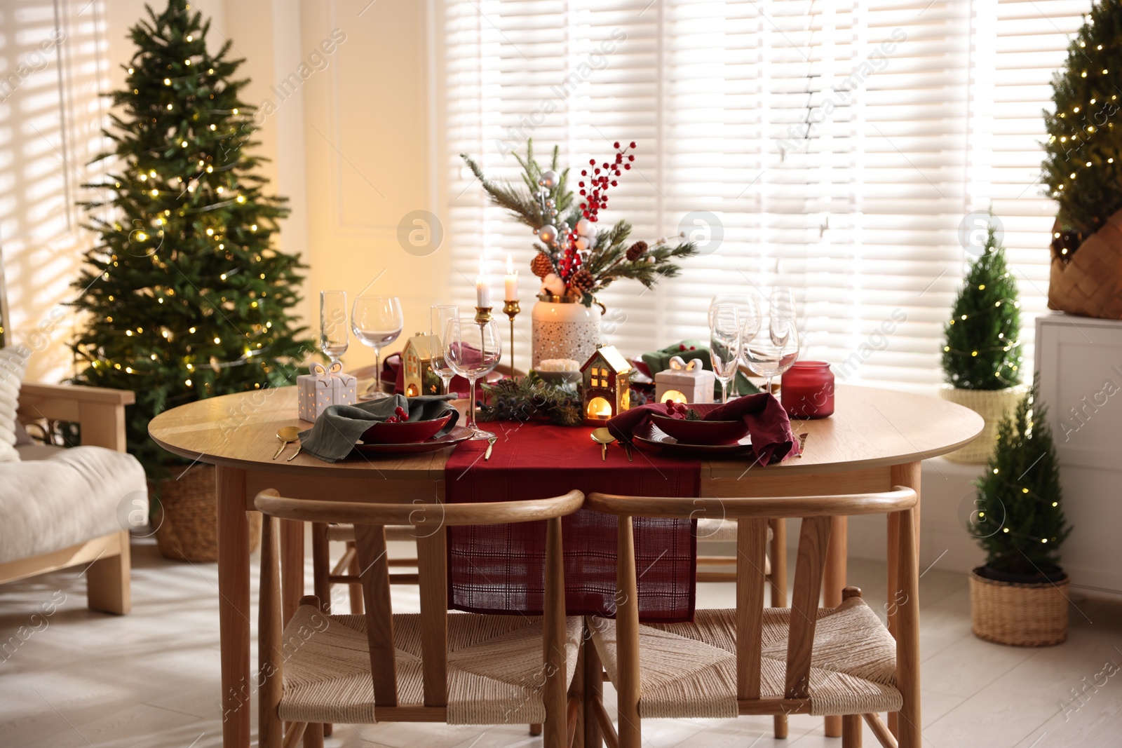 Photo of Christmas table setting with stylish dishware and festive decor indoors