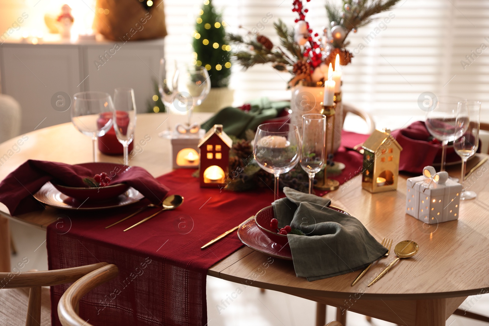 Photo of Christmas table setting with stylish dishware and festive decor indoors