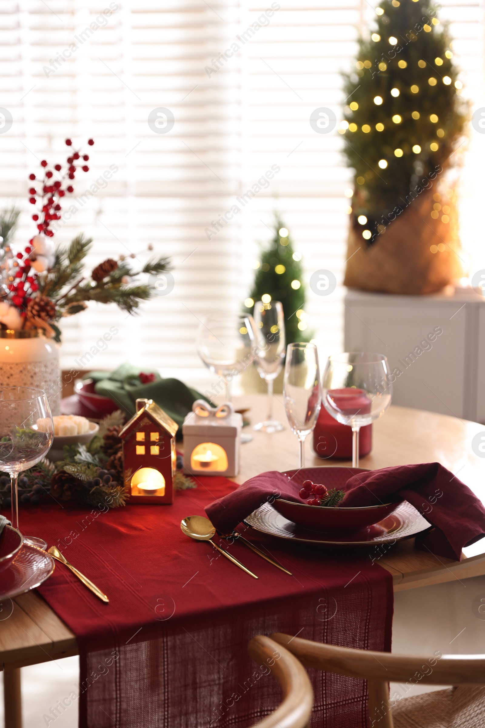 Photo of Christmas table setting with stylish dishware and festive decor indoors