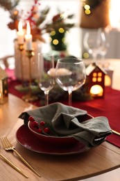 Photo of Christmas table setting with stylish dishware and festive decor indoors