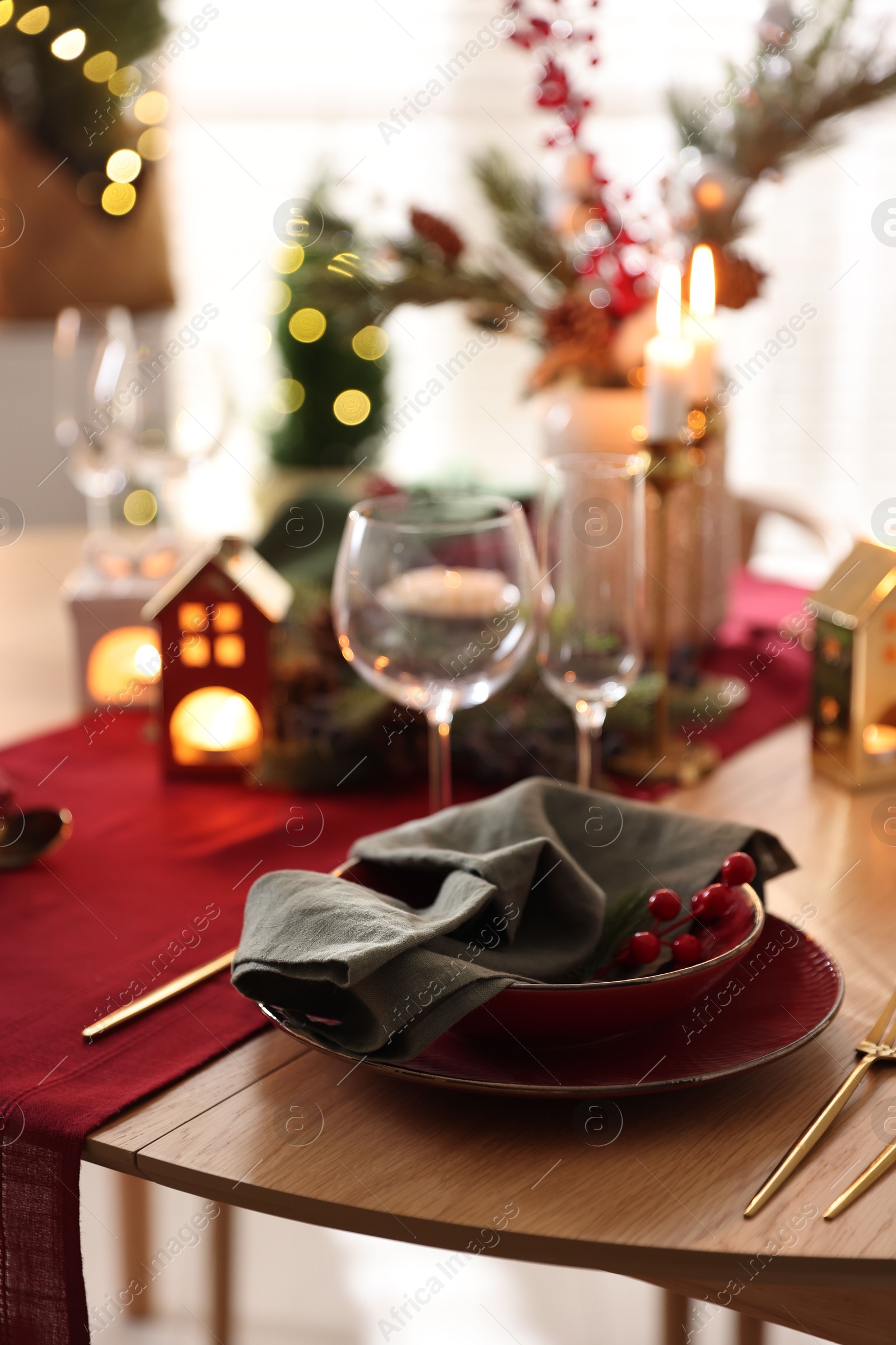 Photo of Christmas table setting with stylish dishware and festive decor indoors