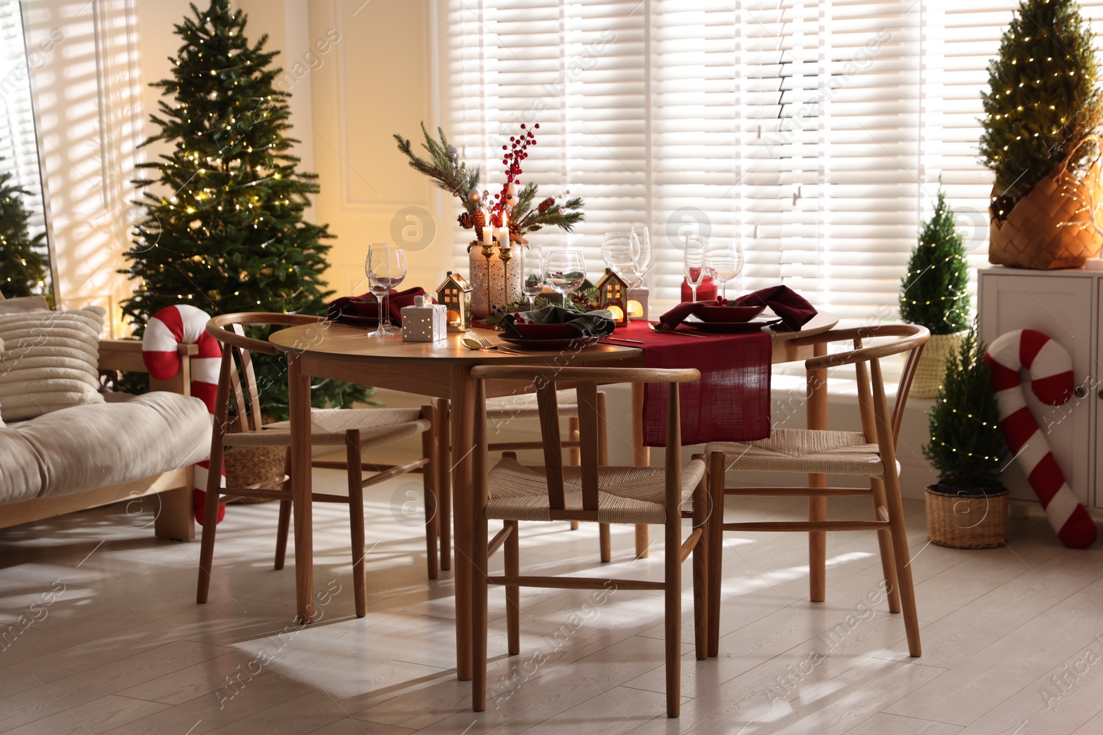 Photo of Christmas table setting with stylish dishware and festive decor indoors