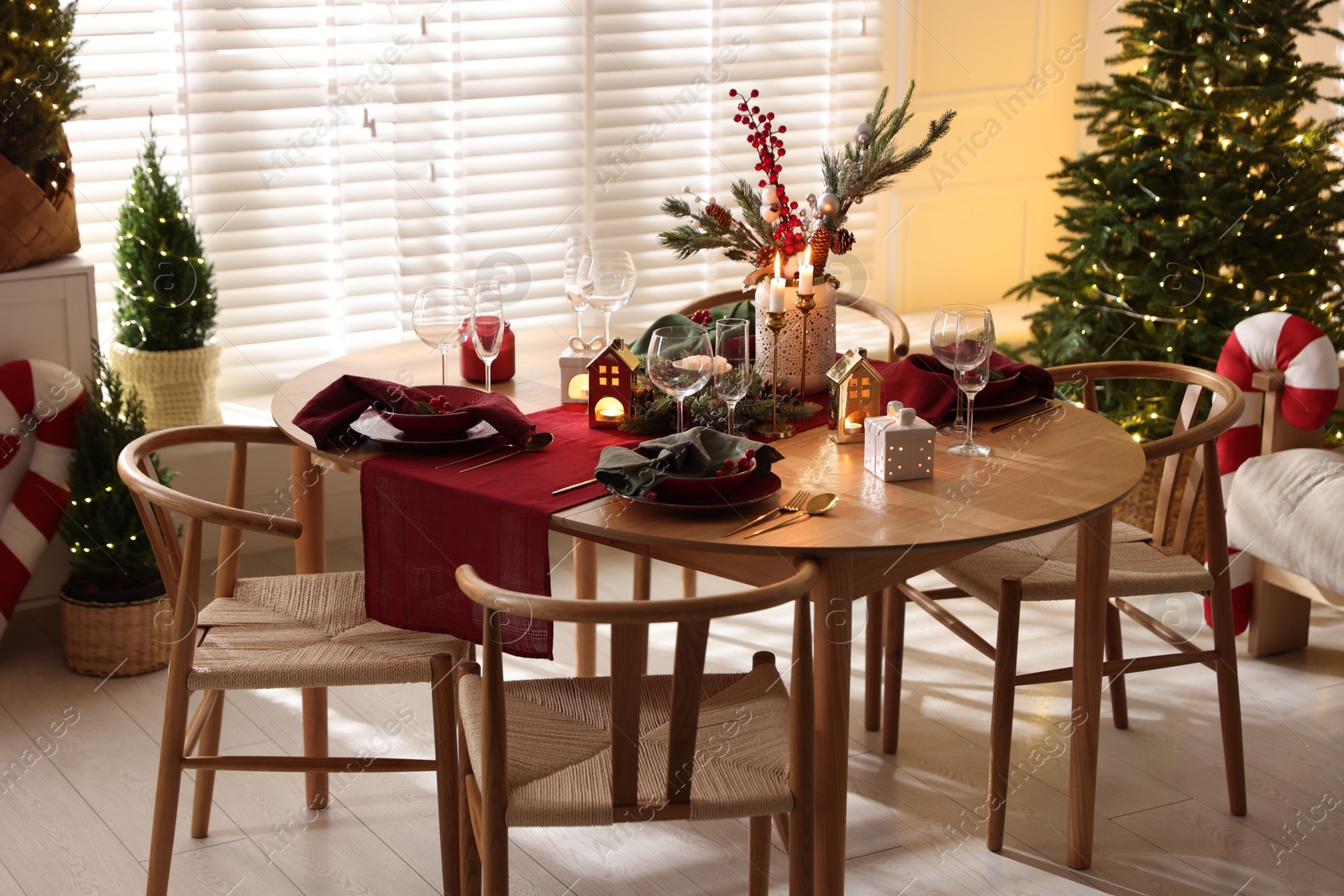 Photo of Christmas table setting with stylish dishware and festive decor indoors