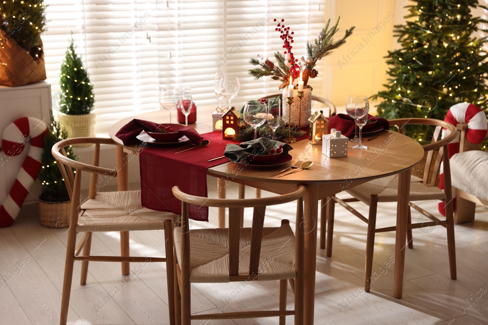 Photo of Christmas table setting with stylish dishware and festive decor indoors