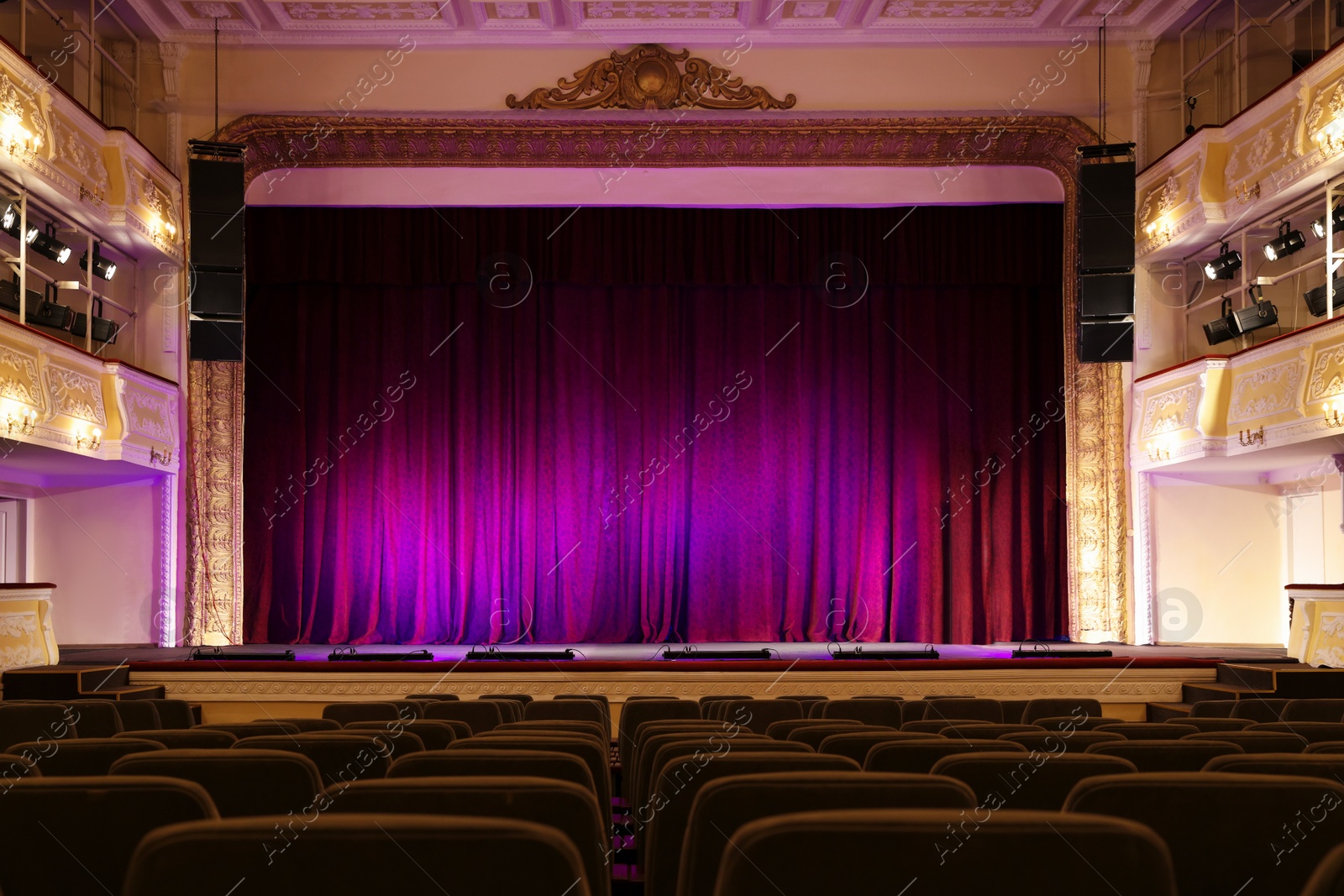 Photo of Theatre interior with stage and rows of comfortable seats