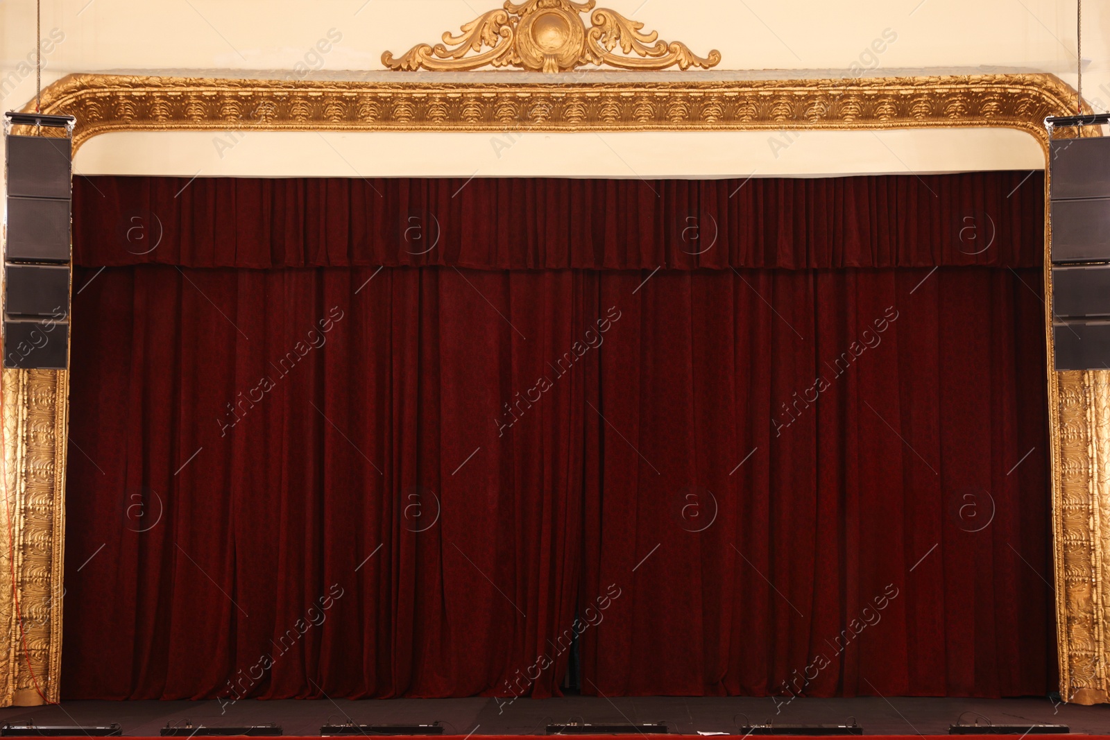 Photo of Elegant closed curtains on stage in theatre