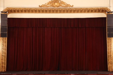 Photo of Elegant closed curtains on stage in theatre