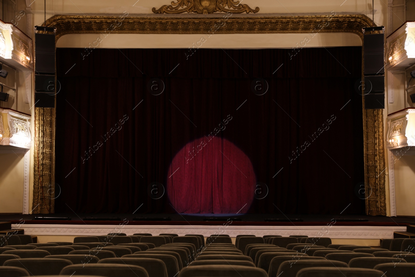 Photo of Theatre interior with stage and rows of comfortable seats