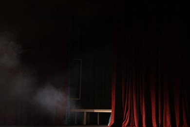 Photo of Smoke on dark stage in modern theatre