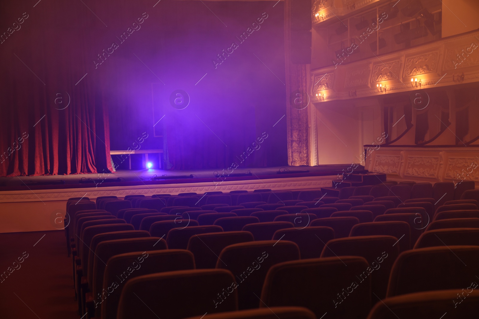 Photo of Professional spotlight and smoke on stage in theatre