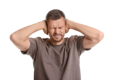 Photo of Man covering his ears on white background