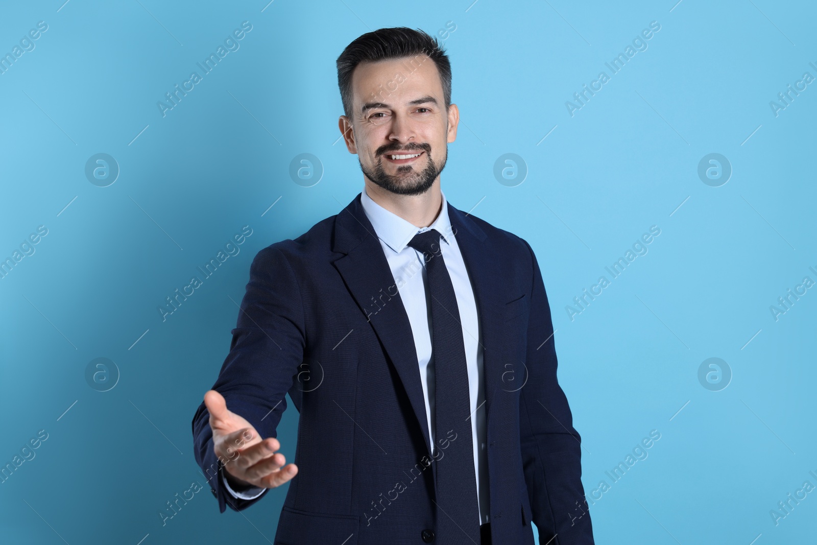 Photo of Portrait of smiling banker on light blue background