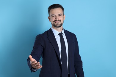 Photo of Portrait of smiling banker on light blue background