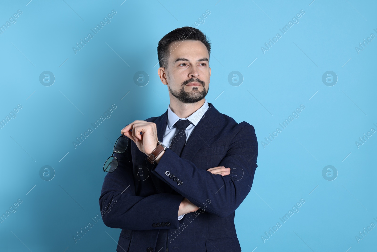 Photo of Portrait of handsome banker on light blue background