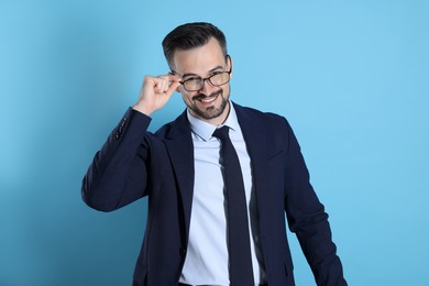 Photo of Portrait of smiling banker on light blue background