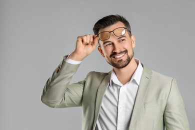 Photo of Portrait of smiling banker on grey background