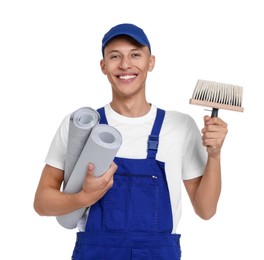 Photo of Young decorator with rolls of wallpaper and brush on white background