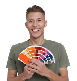 Photo of Portrait of young decorator with color palettes on white background