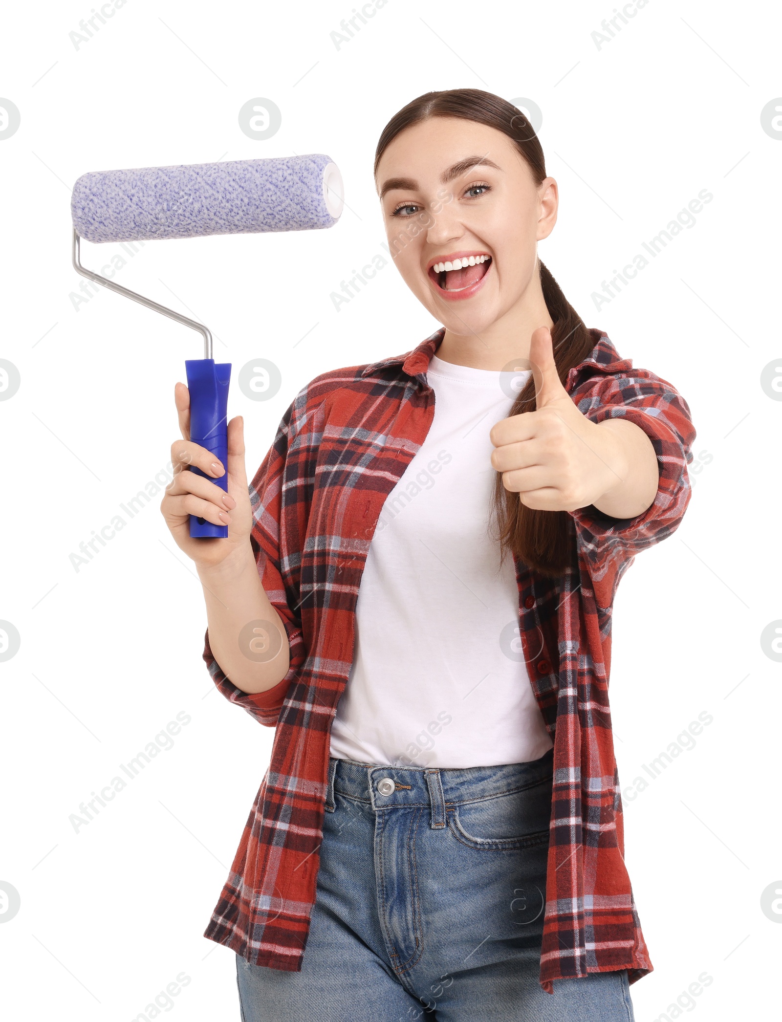 Photo of Portrait of young decorator with paint roller showing thumbs up on white background