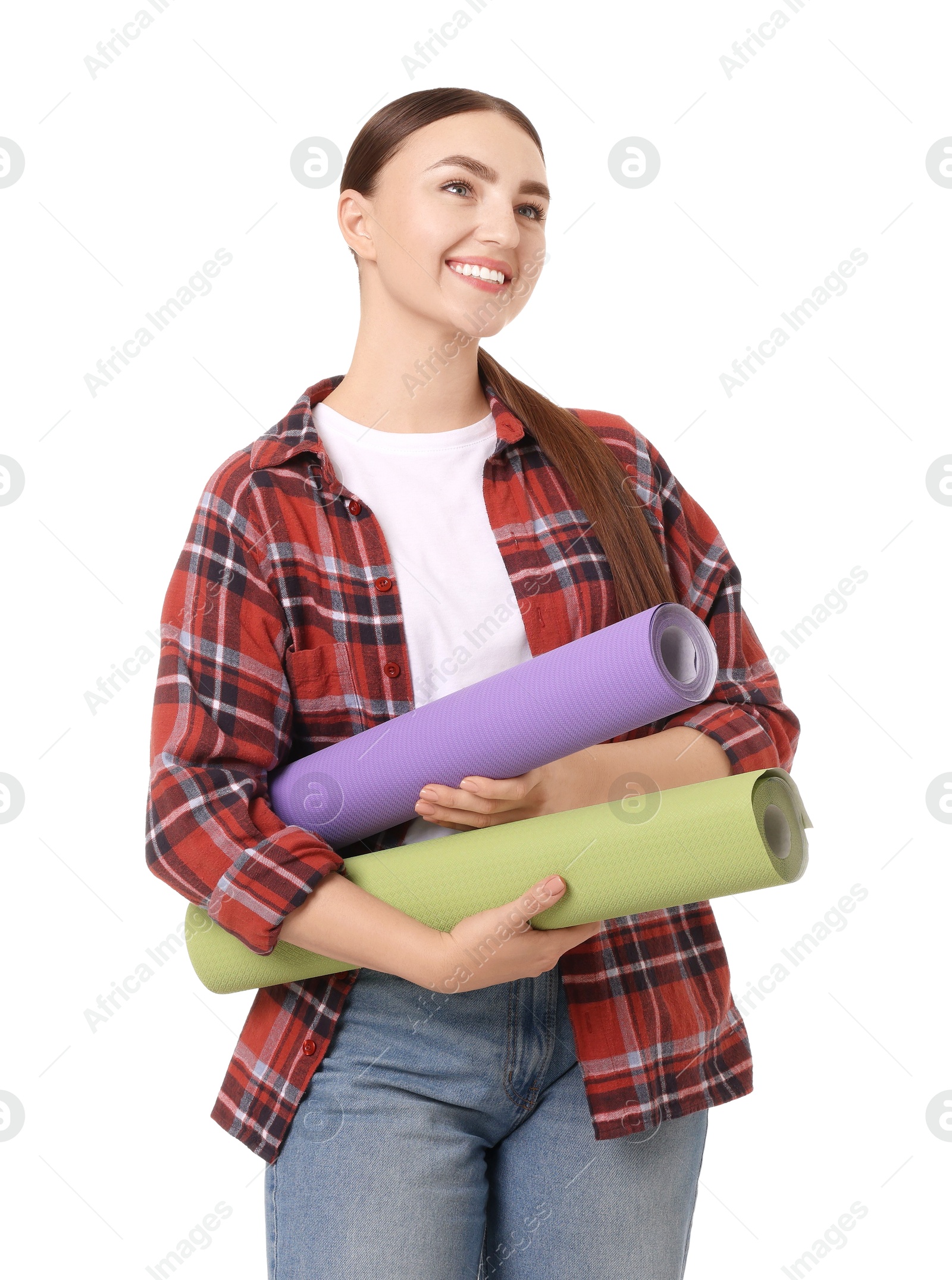 Photo of Young decorator with rolls of wallpaper on white background