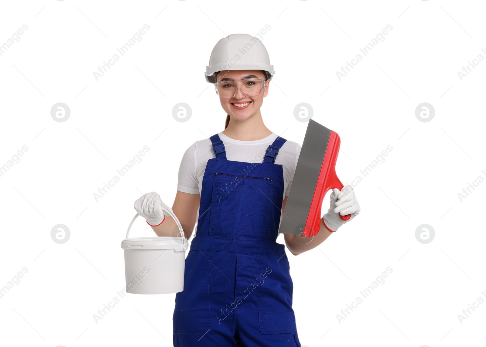 Photo of Portrait of young decorator with putty knife and paint bucket on white background