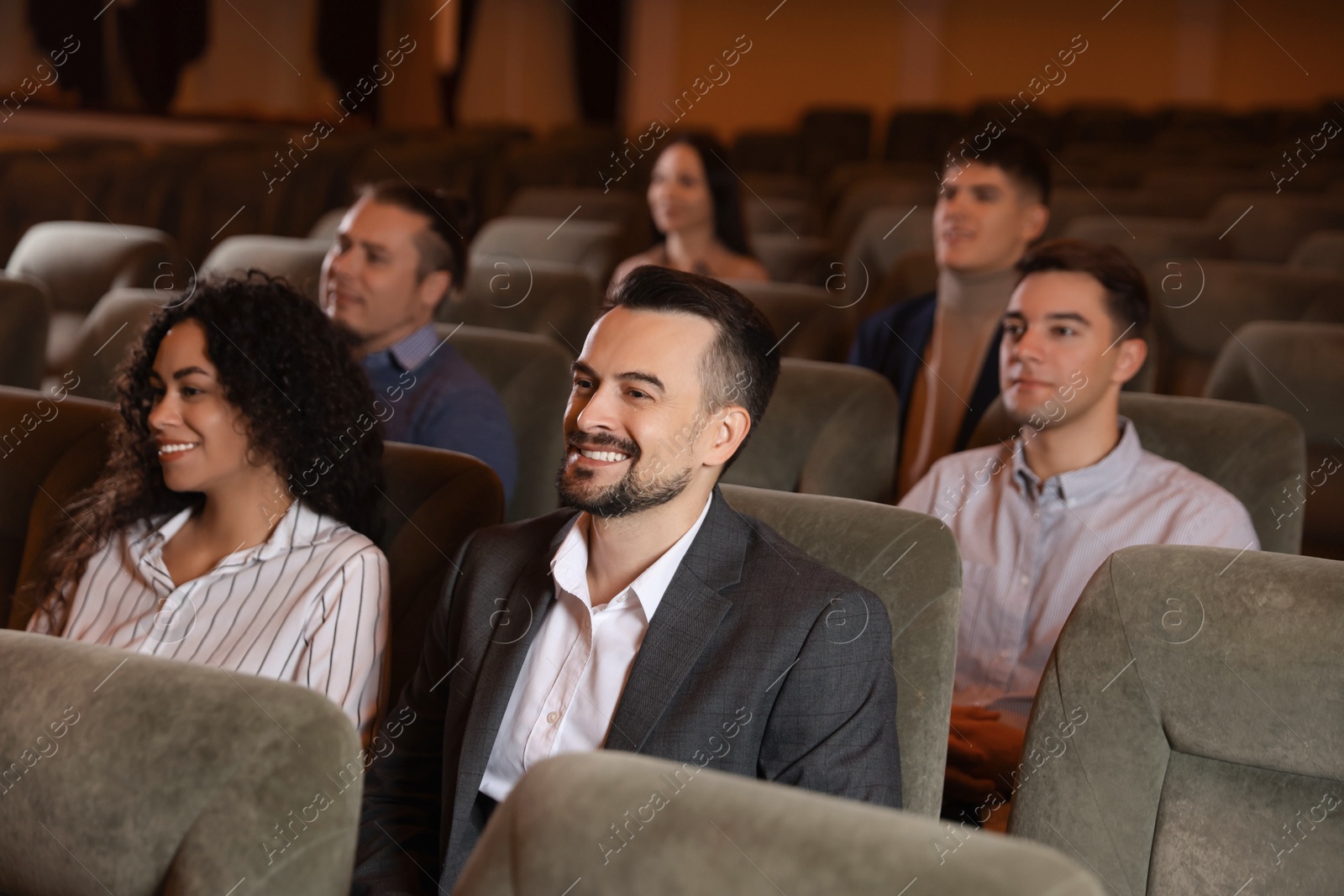 Photo of Group of people watching theatrical performance in theatre