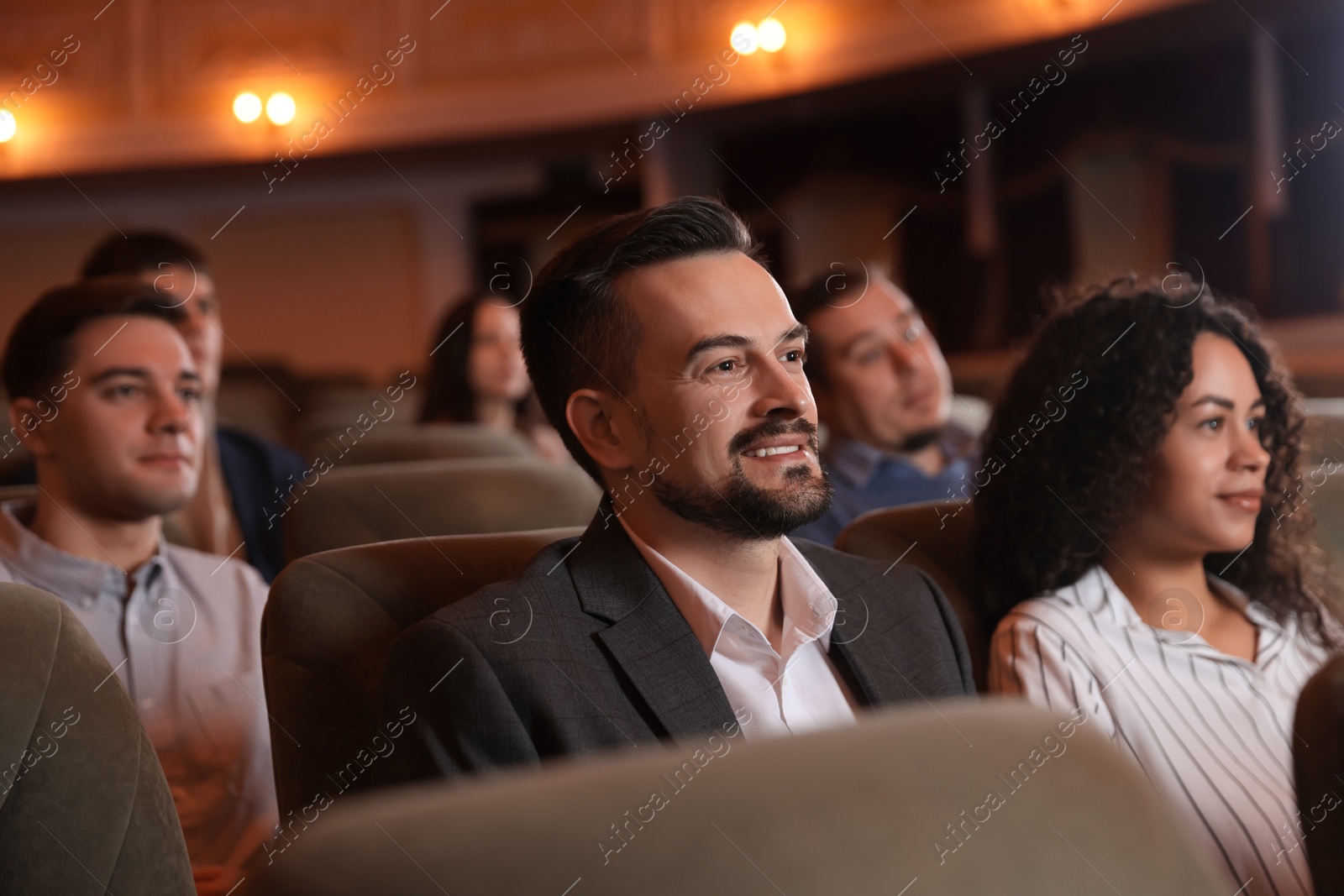 Photo of Group of people watching theatrical performance in theatre