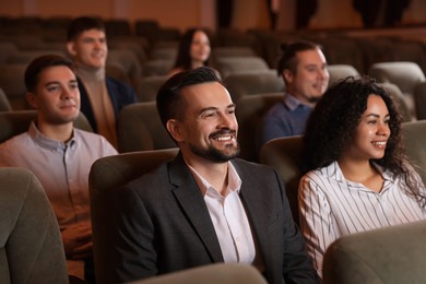 Photo of Group of people watching theatrical performance in theatre