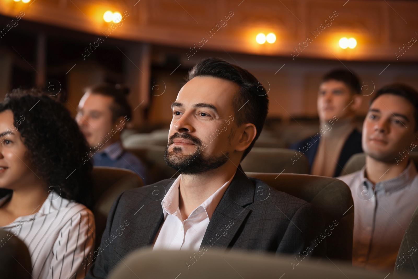 Photo of Group of people watching theatrical performance in theatre