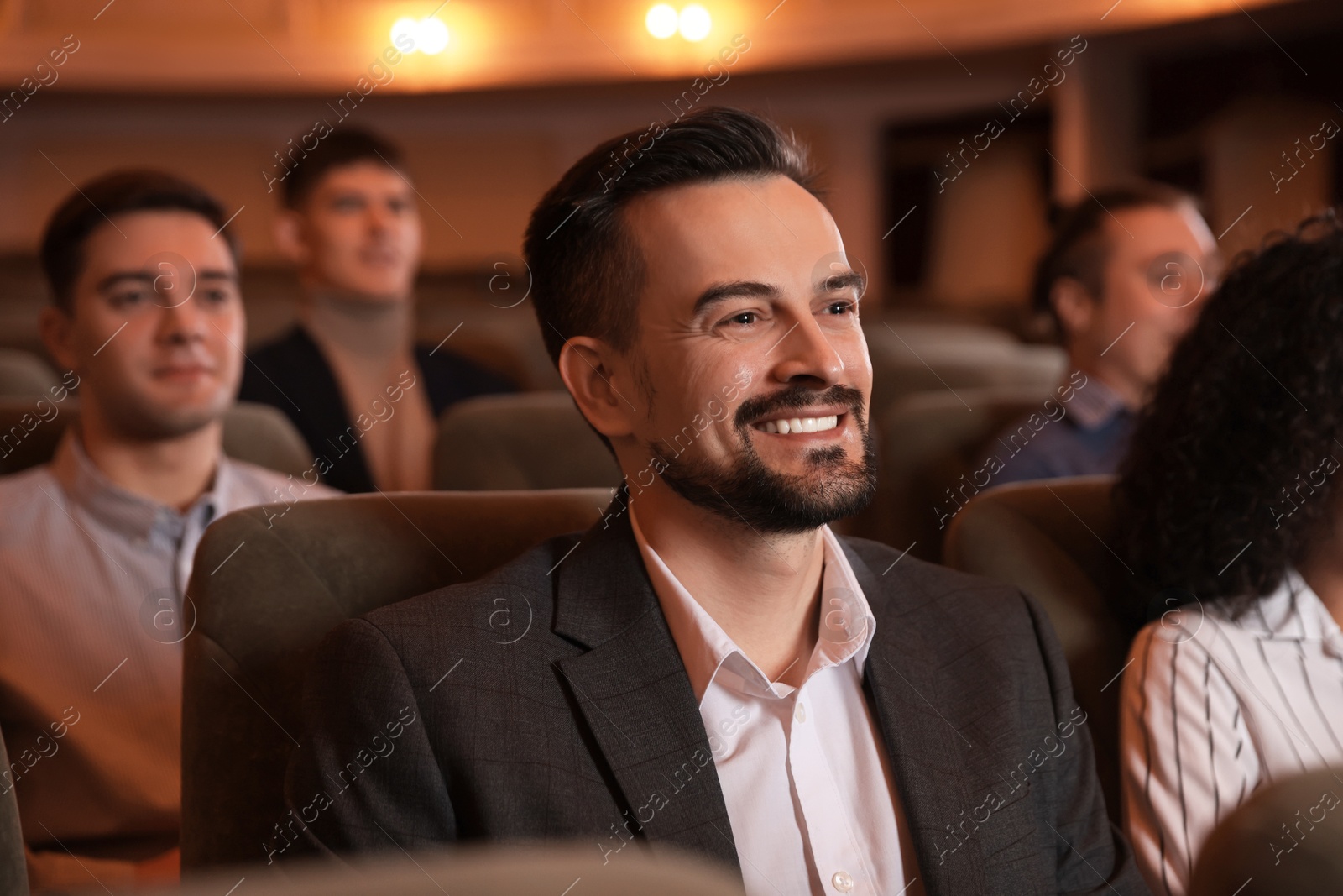 Photo of Group of people watching theatrical performance in theatre