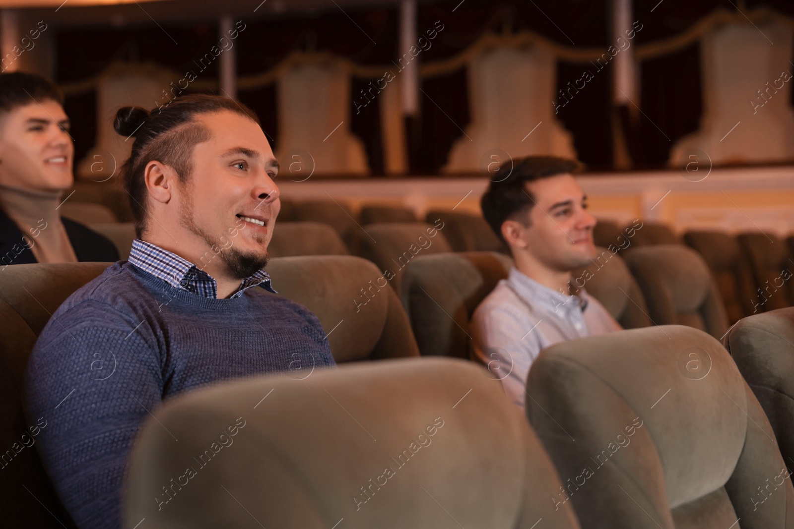 Photo of Group of people watching theatrical performance in theatre