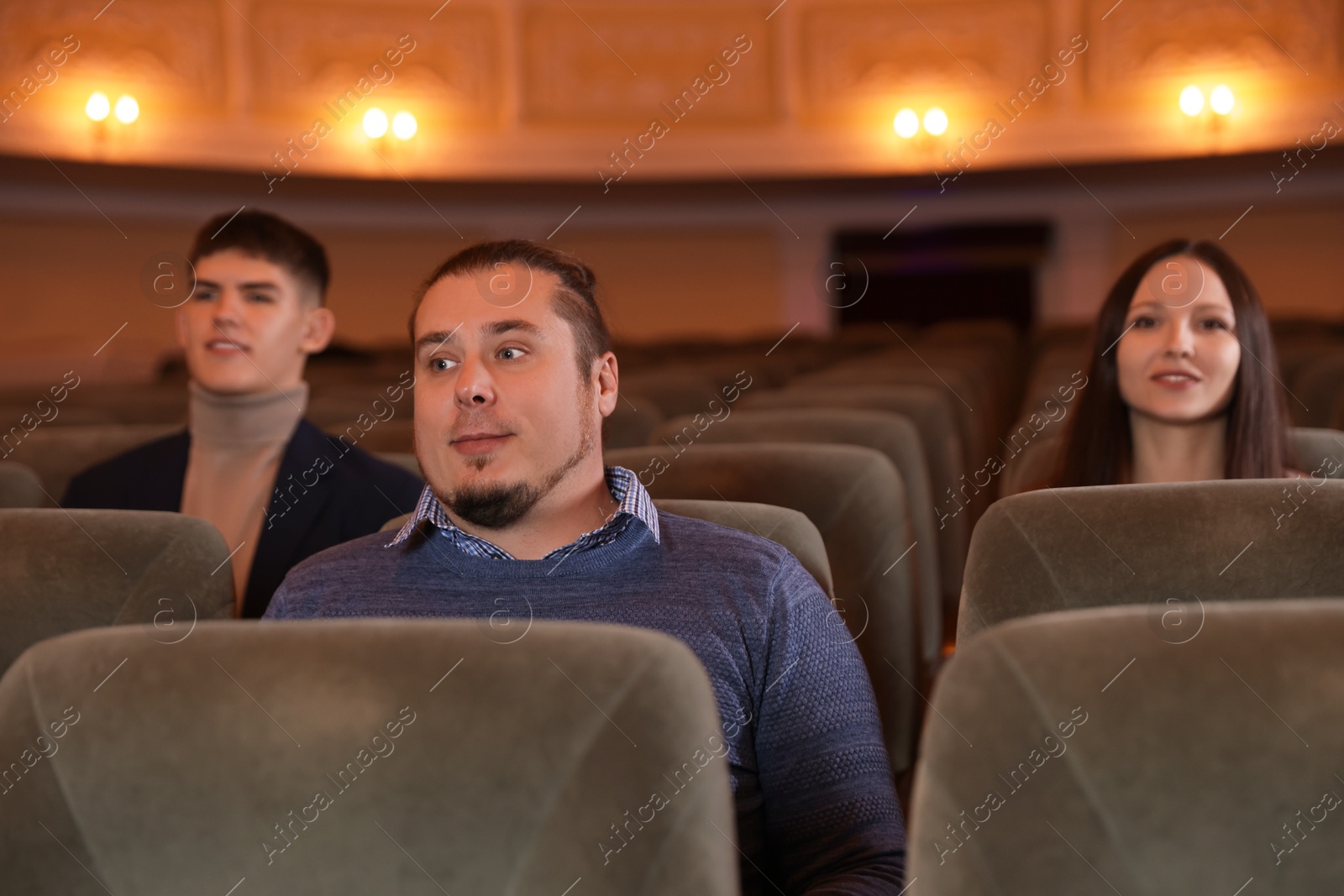 Photo of Group of people watching theatrical performance in theatre